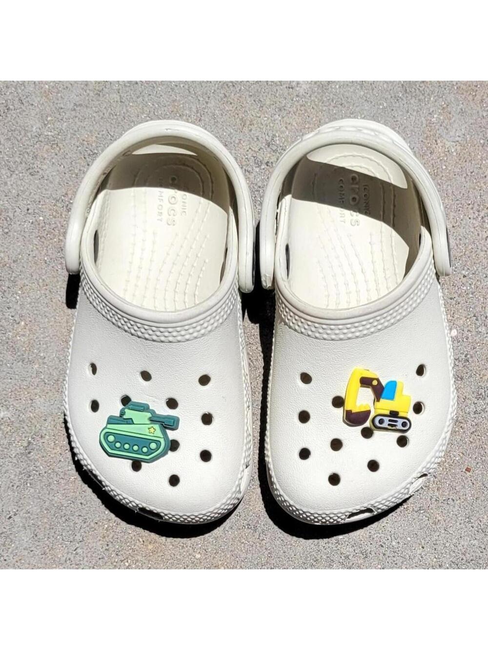 Size C7, child 7. Cute off white Crocs with clog charms. Pre-owned, excellent.